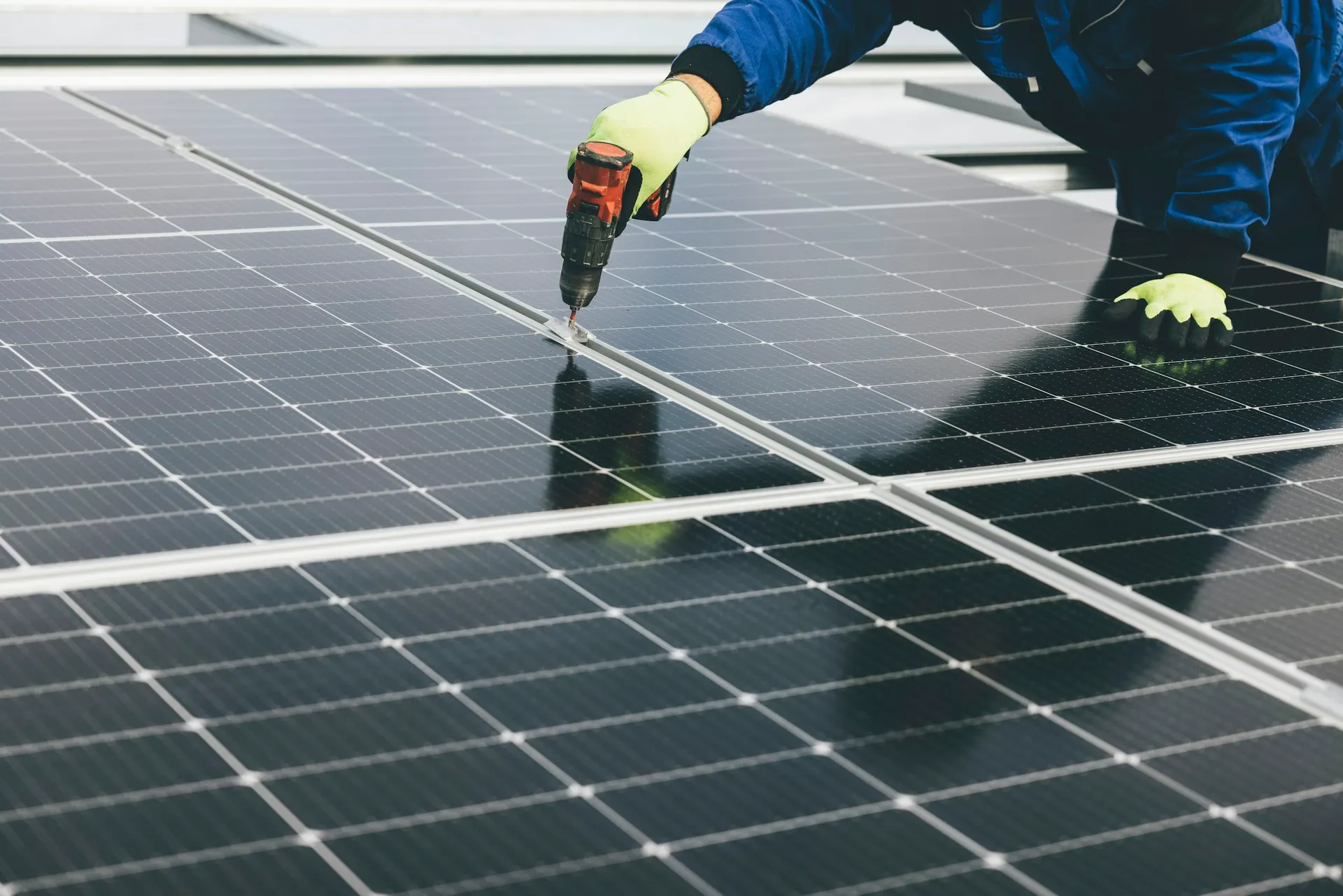 Engineer installing solar panels on a roof